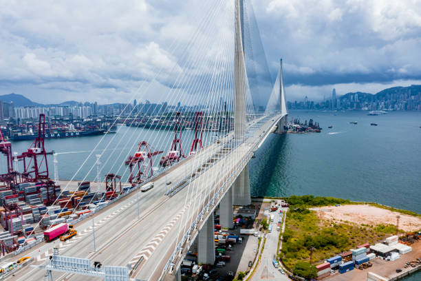 istock Highway Bridge in Hong Kong and Container Cargo freight ship 1252701990