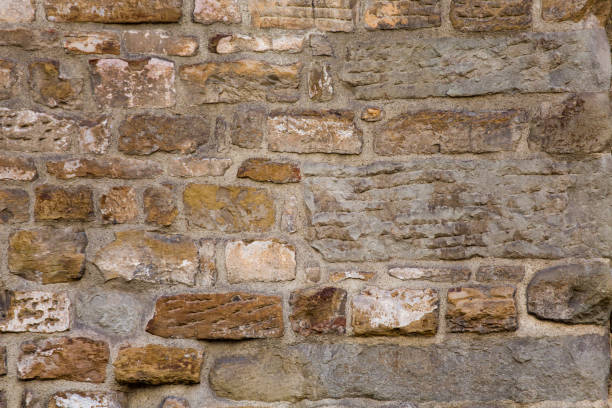 istock Grunge ancient brick stone wall of light beige color. Abstract texture or background 1252704522