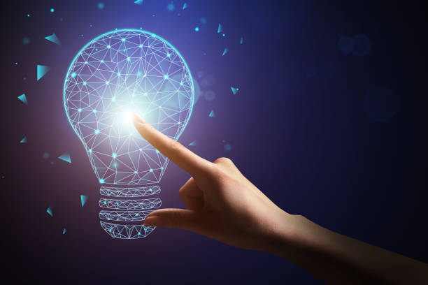 istock Glow in dark. Female hand clicks on light bulb with finger, shards fly around 1252704561