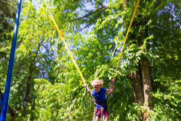 istock Girl bungee jumping in trampoline 1252704943