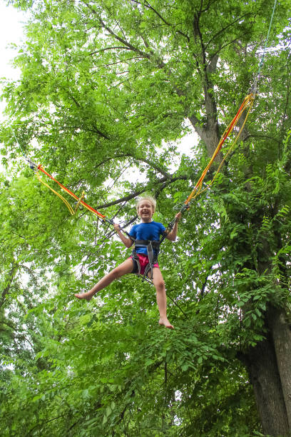 istock Girl bungee jumping in trampoline 1252705594