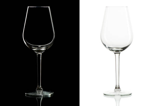 istock Empty tall wine glasses on black and  white background, isolated 1252705979