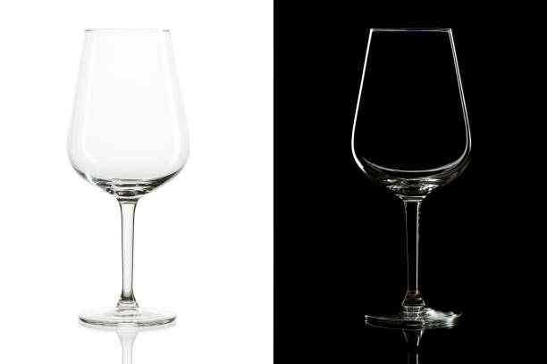 istock Empty tall wine glasses on black and  white background, isolated 1252705982