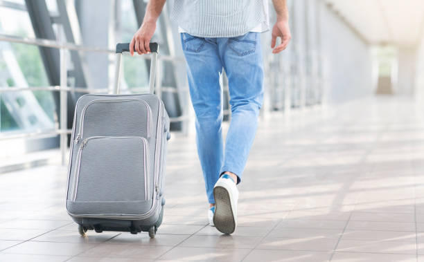 istock Unrecognizable Man Walking With Suitcase In Airport, Going To Boarding Gate 1252705999