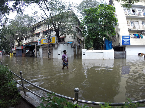 Chennai, India - 2 December 2015: A man wades through a flooded street in Channai, India.