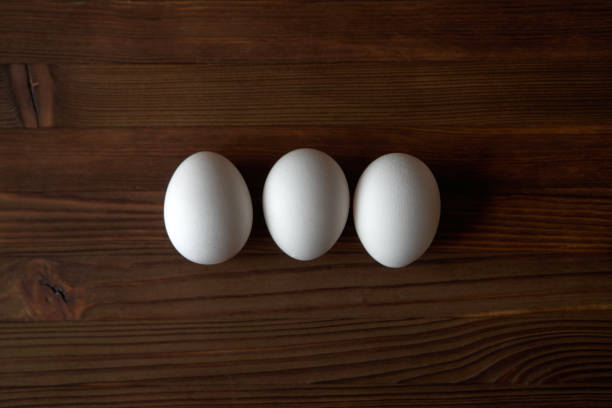 istock Eggs on wooden background. View from above. 1252710066