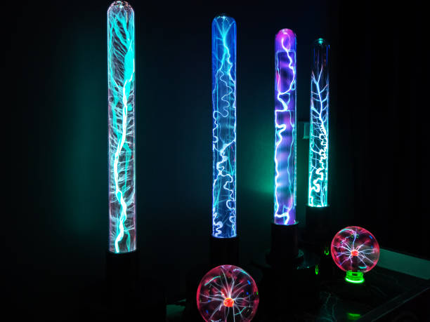 istock Elongated and spherical flasks with electric discharges in the dark 1252710304