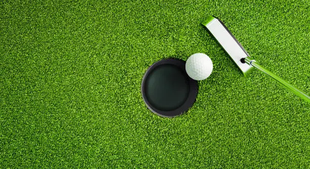 Golf ball with putter on green course at hole - 3D illustration