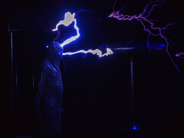 istock Huge electric coils spew lightning striking a man dressed in a chain suit. Electric show 1252711468