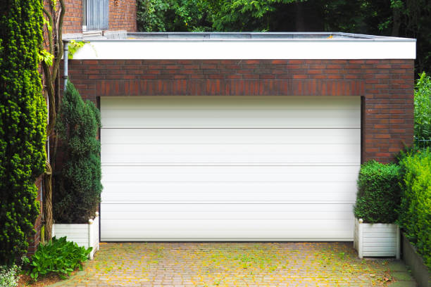 istock Garage concept. Brick car garage with closed white door 1252714374