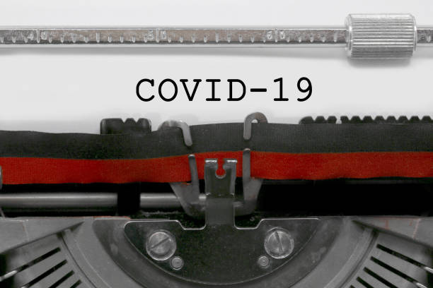 istock old typewriter with the inscription Covid-19 1252714654