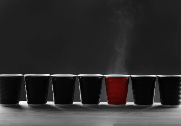 Black and red glasses on grey background. Concept of difference