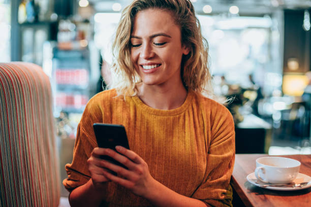 istock Woman texting on her smart phone at cafe. 1252716478