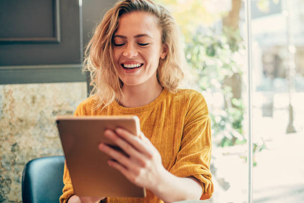 istock Woman using digital tablet at cafe. 1252716479