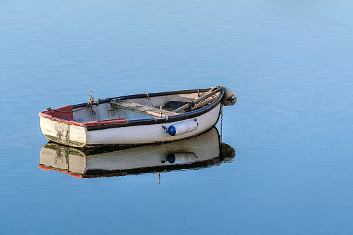 white wooden fishing boat in a calm sea