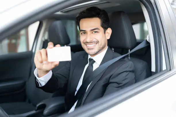 Photo of Businessman Showing Identity Card In Car