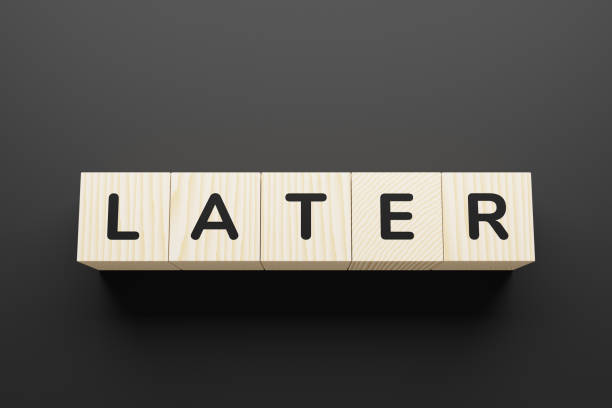 istock LATER word on a wooden blocks. 1252722063