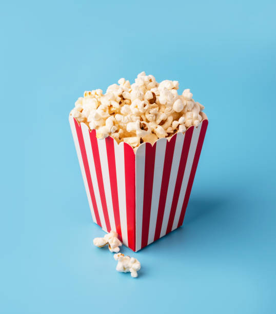istock classic red and white box of popcorn isolated on blue 1252724706