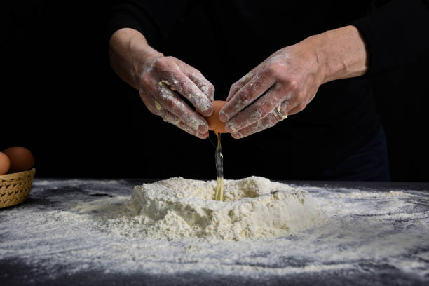 istock A professional baker prepares bread dough in the studio as a model 1252726836