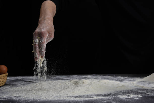 istock A professional baker prepares bread dough in the studio as a model 1252726848