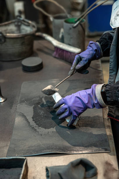 istock Laboratory assistant pours a sample of crushed iron ore 1252732219
