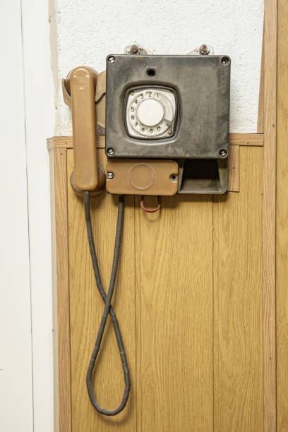 istock Old wall mounted industrial disk telephone hanging on a wall 1252732221