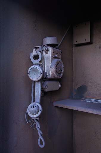 Old dust-covered disk telephone, factory communications