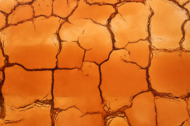 istock background - cracked clay is covered with water after rain 1252734337