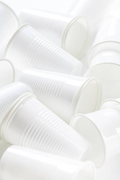 istock Disposable white plastic cups as background. Environmental concept. Non-compostable waste. In blue tone. 1252735213