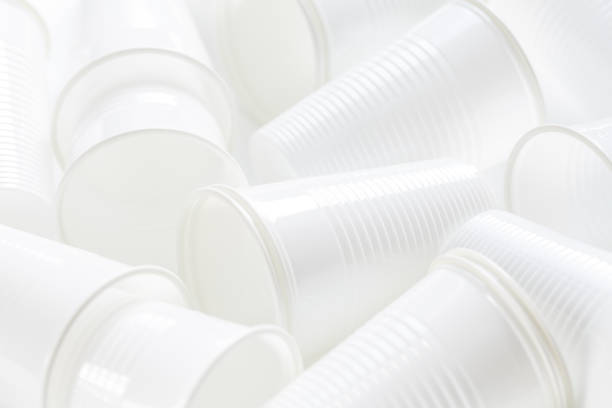 istock Disposable white plastic cups as background. Environmental concept. Non-compostable waste. In blue tone. 1252735220