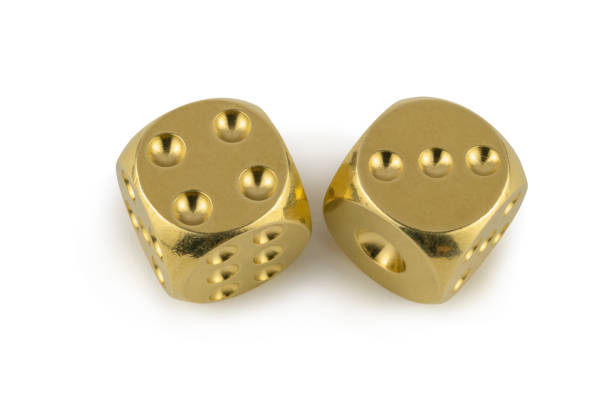 istock Two golden dices closeup isolated on white background. Four and three, with a shadow. 1252735518