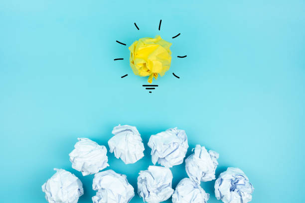 istock Creative idea, Inspiration, New idea and Innovation concept with Crumpled Paper light bulb on blue background. 1252736231