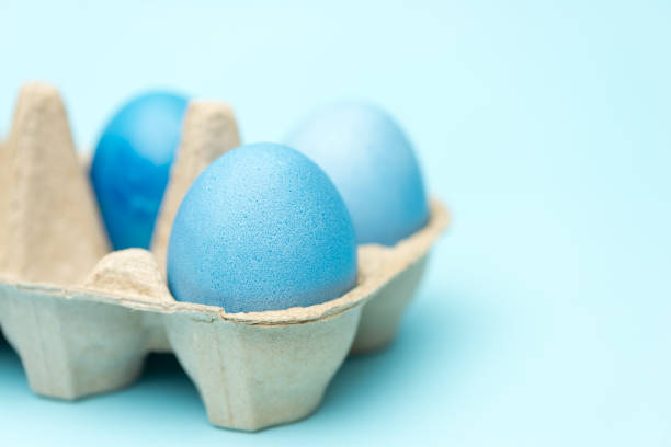 istock Easter eegs in the box on blue background, monochrome close-up view 1252736286