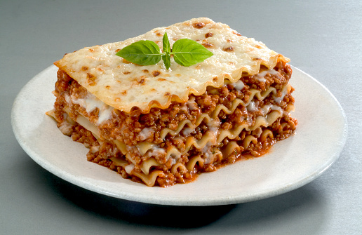Traditional Italian pasta, lasagna is made with minced beef bolognese sauce with tomato, basil, and Mozzarella cheese.\