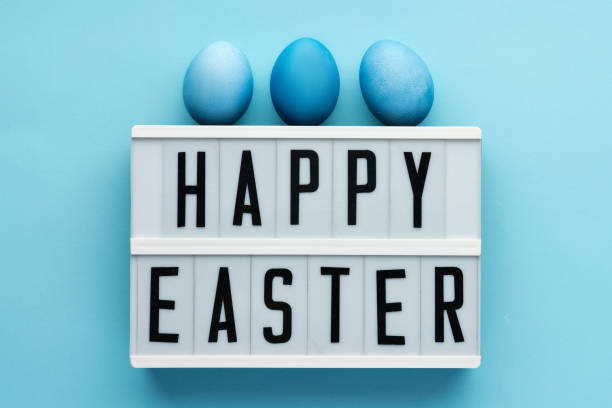 istock Wishing happy easter on blue background with eggs, monochrome view 1252736453