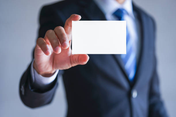 istock Businessman holding white business card. 1252736532