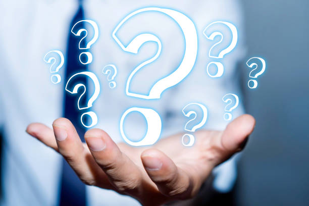 istock Businessman with question marks in his hand. 1252736627