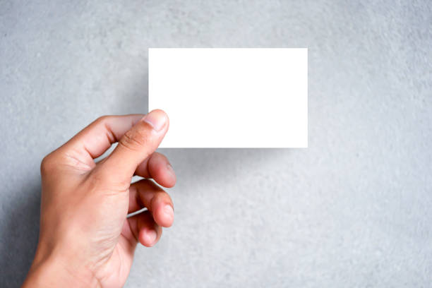 Businessman holding white business card. stock photo