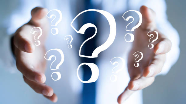 istock Businessman with question marks in his hand. 1252736901