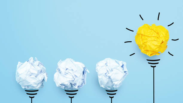 istock Creative idea, Inspiration, New idea and Innovation concept with Crumpled Paper light bulb on blue background. 1252738068