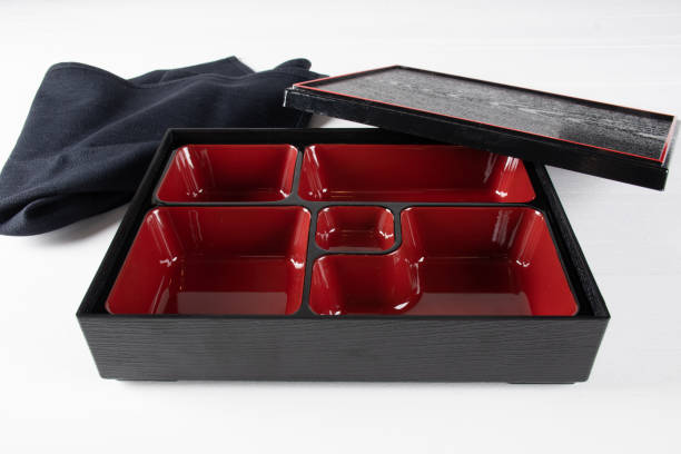 Red and black empty bento box, traditional japanese tray made for lunch Red and black empty bento box, traditional japanese tray made for lunch food meals including sushi, nigiri, sashimi specialties empty bento box stock pictures, royalty-free photos & images