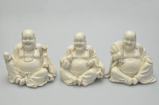 Three laughing white Buddhas stock photo