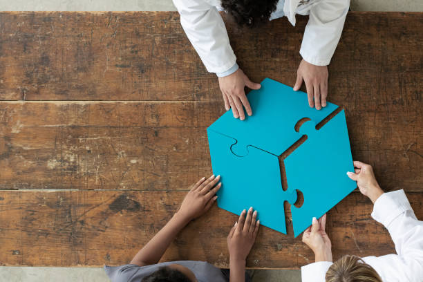 istock Professionals assembling 3 par puzzle piece, aerial view 1252738509