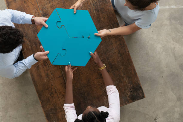 istock Professionals assembling 3 par puzzle piece, aerial view 1252738515