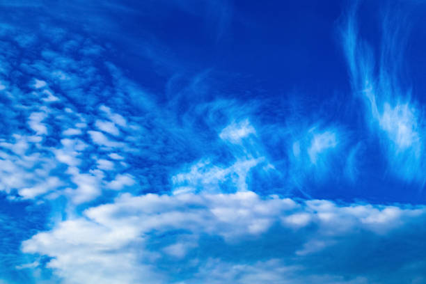 istock Abstract illustration of white light clouds against a blue sky. 1252738680