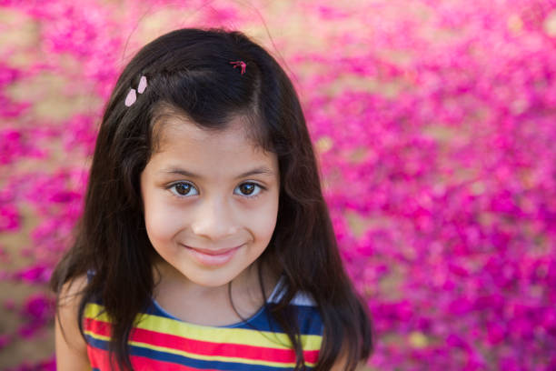 Royalty free stock photo of little girl (5-6) looking pensive. Shot with shallow depth of field.This file has a