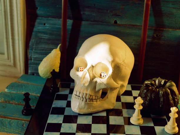 istock Halloween, mystical composition of a skull, pumpkins, frames on a chessboard with figures 1252748130