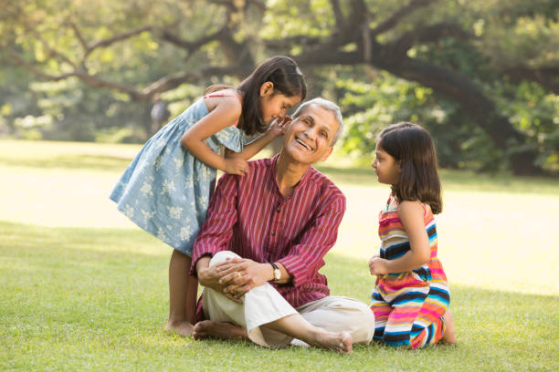 famiglia multigenerazionale - immagini stock - whispering grandparent child grandfather foto e immagini stock