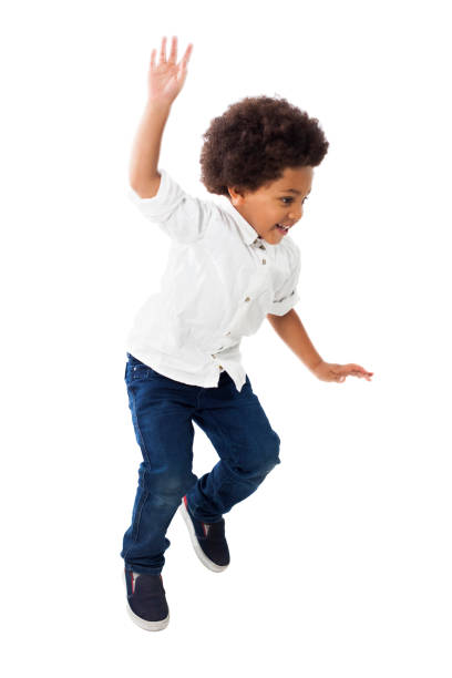 istock Little black boy having fun jumping and smiling 1252756524