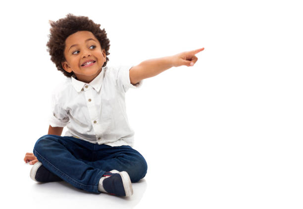 istock Black little boy pointing away smiling 1252756536